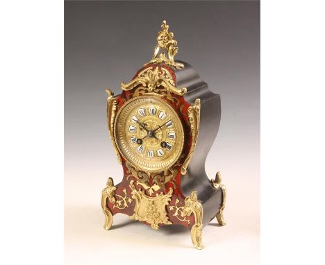 A late 19th Century brass inlaid red Tortoiseshell ebonized ground French Boulle&rsquo; rococo MANTEL CLOCK with leaf cast mo