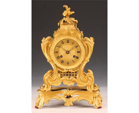 A good mid 19th Century French Rococo Ormolu MANTEL CLOCK the ornate matt gilded leaf cast case with burnished highlights, en