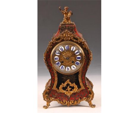 A good 19th Century French red Tortoiseshell and brass inlaid BOULLE MANTEL CLOCK with cast scrolled leaf work mounts headed 