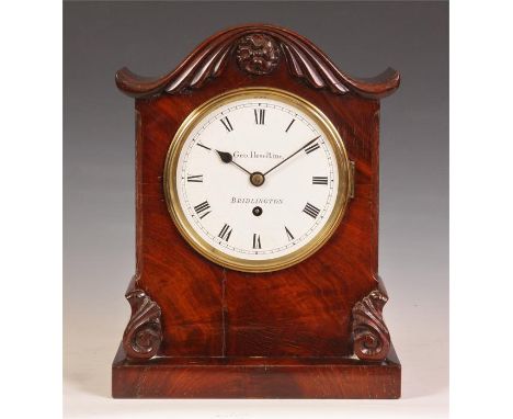 GEO. HESELTINE, BRIDLINGTONA&nbsp; late Regency figured Mahogany BRACKET CLOCK of small size, with carved serpentine pediment