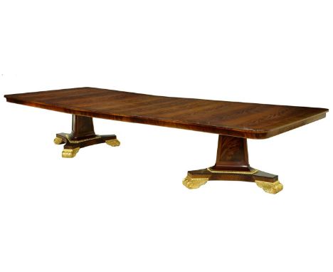 A parcel gilt mahogany twin pillar dining table in Regency style, by R &amp; D Davidson, London,&nbsp;the crossbanded curl ve