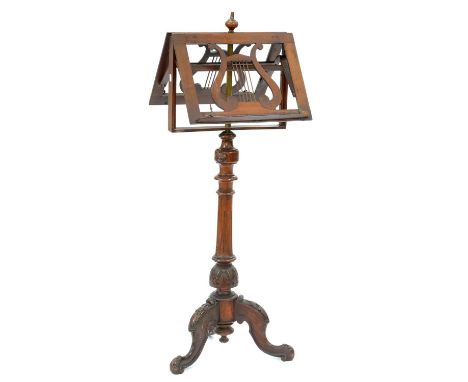 A Victorian walnut music stand, with telescopic twin lyre shaped rests on carved tripod  Complete; dirty, original and unrest