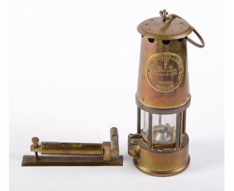 A brass spirit level and a miner's safety lamp by the Protector Lamp &amp; Lighting Co  Good condition