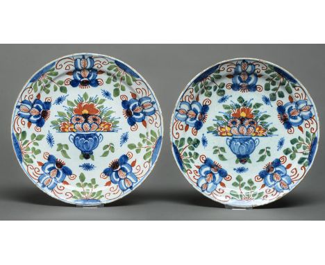 A pair of English Delftware plates, possibly Bristol, c1780, painted in blue, red and green touched with yellow with a vase o