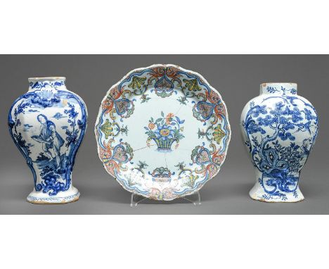 A Rouen faience plate, c1740, decorated in the style Rayonnant with a central flower filled basket flanked by tendrils in an 