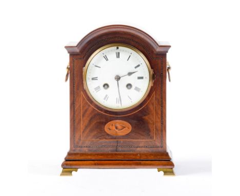 A breakarched mahogany and inlaid mantel clock, c1910, with enamel dial and gong striking movement, on brass ogee feet, pendu