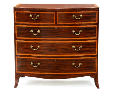 A Regency mahogany bow front chest of drawers, outlined throughout in satinwood, fitted two short over three long graduated d