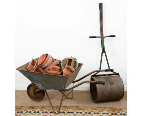 A garden roller, a wheel barrow, terracotta flower pots, etc  Rust and wear, handle of roller repaired