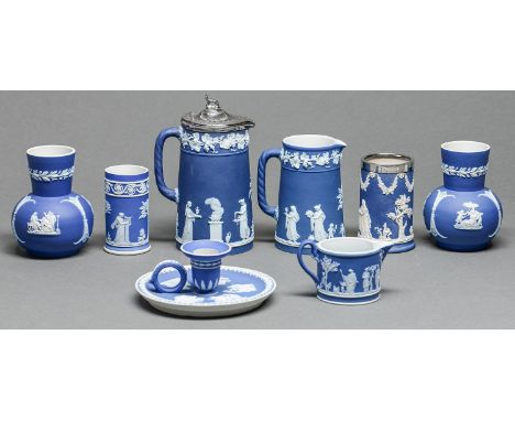 A group of Wedgwood and Adams dark blue jasper dip jugs and other articles, c1900, to include a hand candlestick, all sprigge