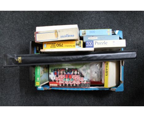 A box of vintage board games and puzzles, cased snooker cue, electronic chess board 