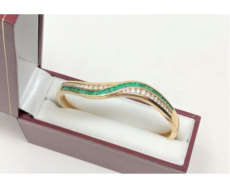 A fine quality 18ct gold emerald and diamond bangle CONDITION REPORT: 26g. 