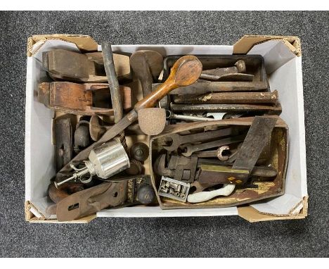 A box of vintage hand tools, spanners, metal chisels, cobbler's last, oil can, wood working planes 