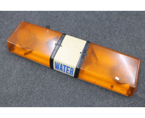 A vehicle roof top emergency light marked 'Water'