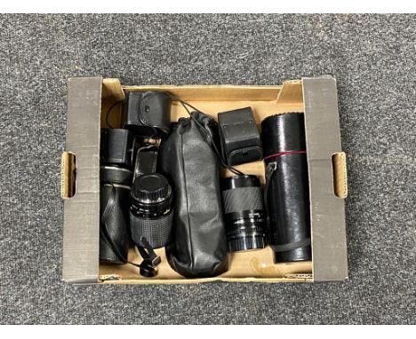 A box of camera lenses, light meter etc 
