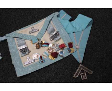 A Freemason's bag and sash together with ten assorted enamelled badges 