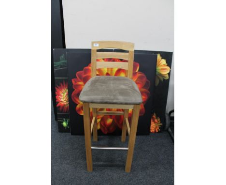 A contemporary bar stool together with three pieces of wall art - flowers 