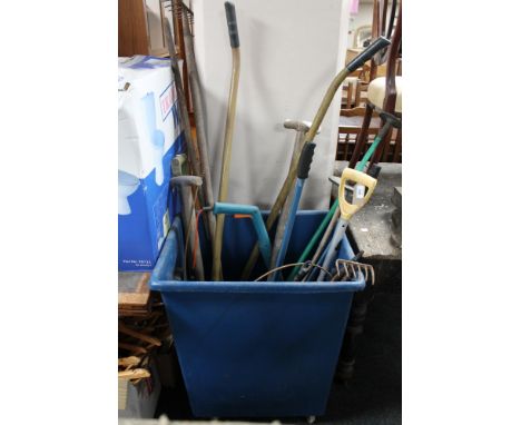 A plastic bin on wheels containing a assorted garden tools 