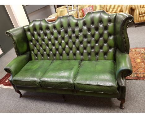 A green leather Chesterfield camel-backed settee, width 184 cm 