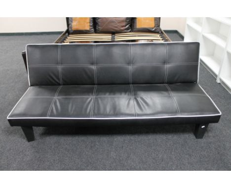 A folding faux leather bed settee 