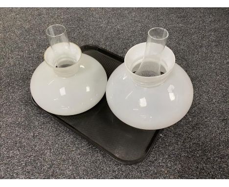 A tray of two vintage glass oil lamp shades and chimneys 