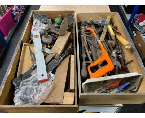 Two oak drawers containing hand tools, cobbler's last, spirit level, oil lamp bases 