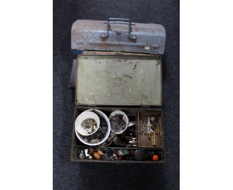 A metal tool box, tins containing hand tools and hardware 