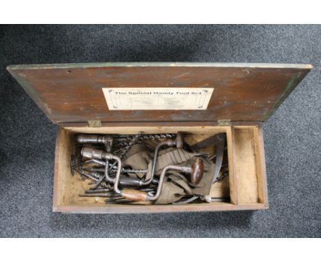 A vintage wooden tool box, hand tools including drill bits, braces etc 