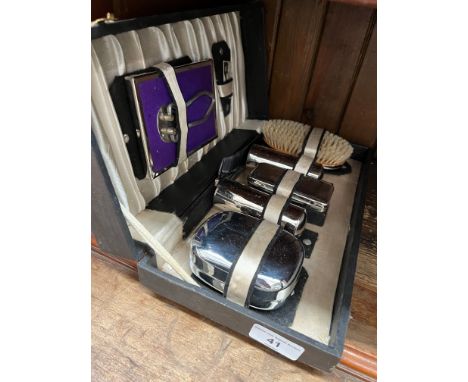 A vintage travel grooming set. 