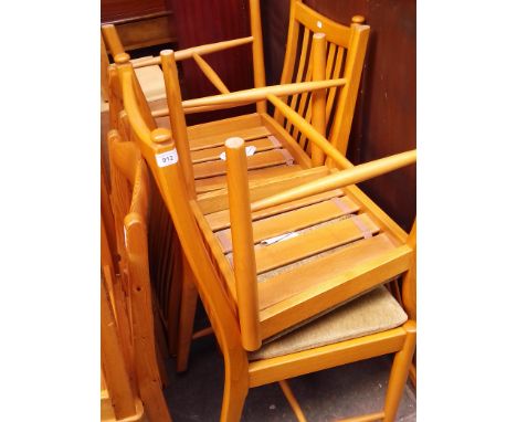A set of four modern Ercol light elm dining chairs. 