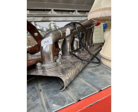 An exhaust manifold modified to lamp and a metal U shaped item. 