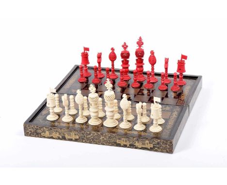 Chess pieces and case / board, carved ivory, one of the sets dyed red, lacquered and gilt wood case / board "Chinoiseries", A