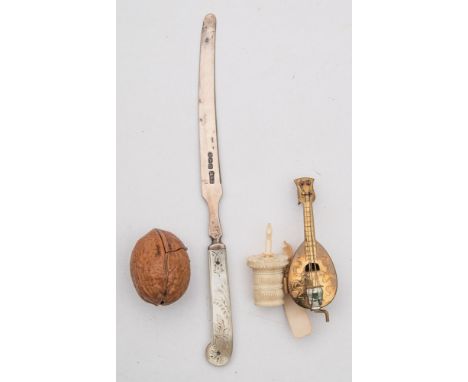 A 19th century gilt metal novelty tape measure in the form of a mandolin:, a turned ivory tape measure, a mother of pearl han