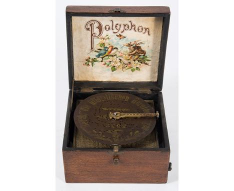 A late 19th /early 20th century Polyphon:, the case with gilt stenciled title and border enclosing mechanism number 1077, lit