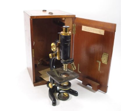 A black lacquer 'Service' microscope by Watson &amp; Sons, London:, coarse and fine adjust, triple objectives and static stag