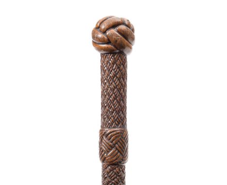 A late 19th century rope carved walking stick:, with two simulated ferrules and a monkey fist pommel, 92cm long.