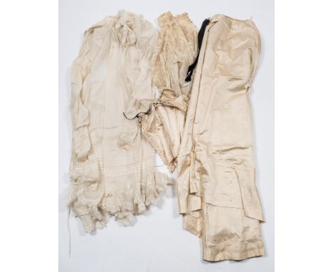 A late Victorian cream silk and lace trimmed bodice and skirt:, together with a cotton under garment and a lace blouse.
