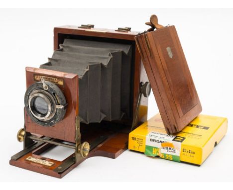 A late 19th century 'Le Mereveilleux' mahogany quarter plate camera by J Lancaster &amp; Sons , Birmingham:, with black bello