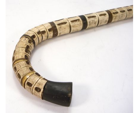 An early 20th century shark vertebrae walking stick:, 91cm.