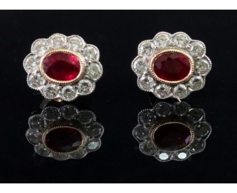 A pair of 18ct gold ruby and diamond-set earstuds of cluster design, the oval-cut rubies collet-set to a surround of circular