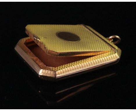An Art Deco 9ct gold engine turned powder compact, Birmingham 1924, of canted rectangular shape, with central vacant disc to 