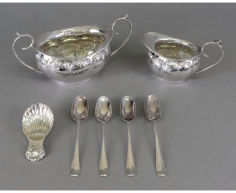 An Edwardian silver oval two-handled sugar basin and milk jug, makers mark C.W. &amp; S, Birmingham 1907, the lobed sides wit