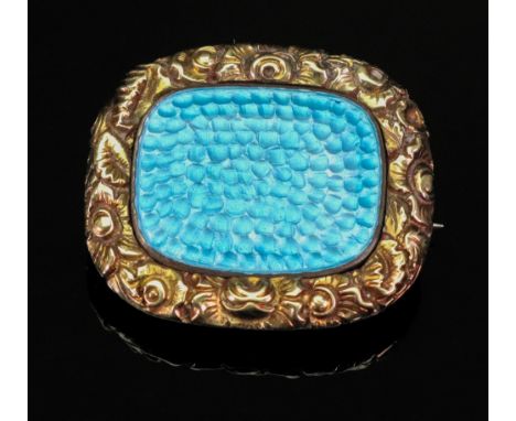 An early Victorian panel brooch, with foliate engraved border, set with a later spot hammered enamel panel, 5.8g gross.