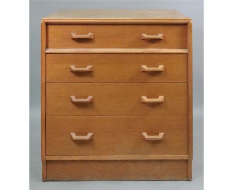 An E Gomme G-Plan light oak chest of four drawers, 76cm wide x 48cm deep x 85cm high.
