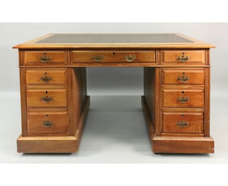 An Edwardian walnut kneehole desk, the inset rectangular top above three frieze and six pedestal drawers, 122cm wide x 67cm d