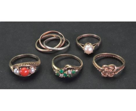 A collection of five 9ct gold and gem-set dress rings; comprising  an emerald and diamond ring of cross over cluster design; 