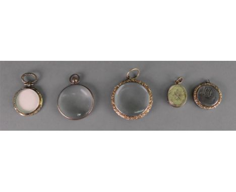 A George III circular memorial locket, engine turned enclosing a monogram and on the reverse side a lock of hair with monogra