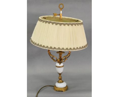 A French gilt metal and white opaline glass three light candelabrum, 20th century, in Louis XVI style, the engine turned vase