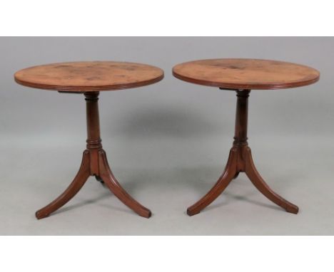 A pair of reproduction George III style yewwood and crossbanded pedestal tables, the circular tops on tripod bases, 46.5cm di