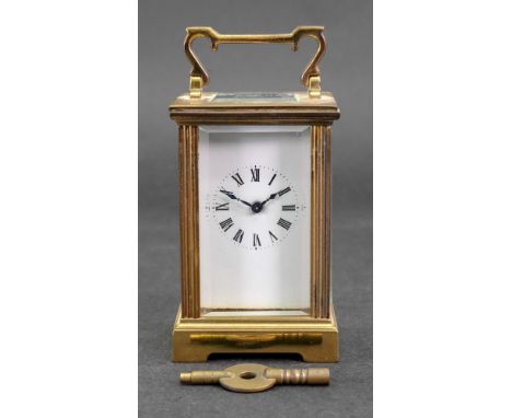 A miniature brass cased carriage timepiece, 20th century, in a pillared case, the white enamel dial with Roman numerals, 11cm