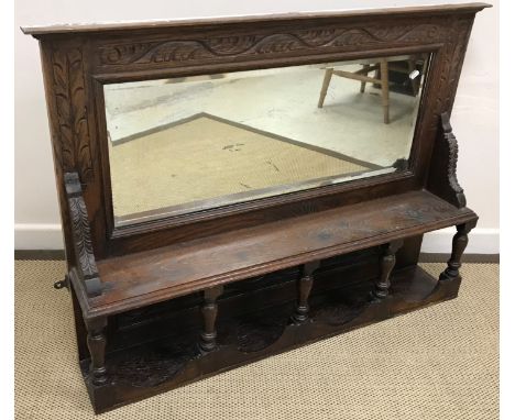 A carved oak part glazed two door cupboard in the Gothic style, 72 cm wide x 31 cm deep x 92 cm high, together with a carved 